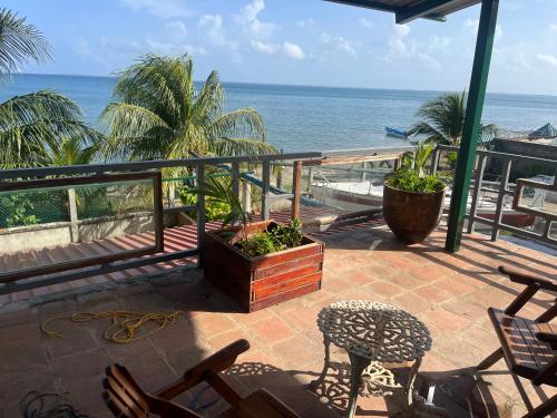 a balcony with chairs and a view of the ocean at Trujillo sail club in Trujillo
