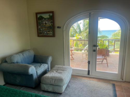 a living room with a chair and a sliding glass door at Trujillo sail club in Trujillo