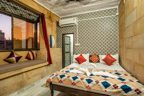 a bedroom with a bed and a window at Peace & Joy in Jaisalmer