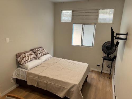 a small bedroom with a bed and a window at Ap Studio Centro Historico in Salvador