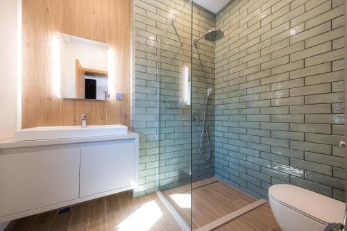 a bathroom with a toilet and a sink and a shower at Къща за гости "Фамилия" in Raduil