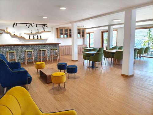 a restaurant with tables and chairs and a bar at Wine House - Quinta Vale de Carvalho in Torre de Moncorvo