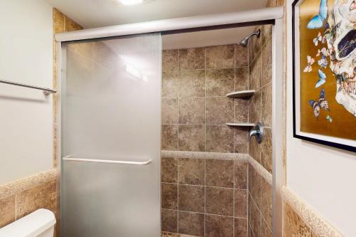a shower with a glass door in a bathroom at White Marlin 208B in Ocean City