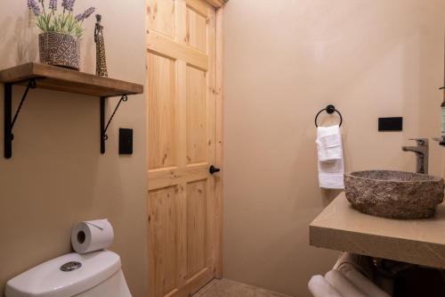 a bathroom with a white toilet and a sink at Marsol 1 in Bahia