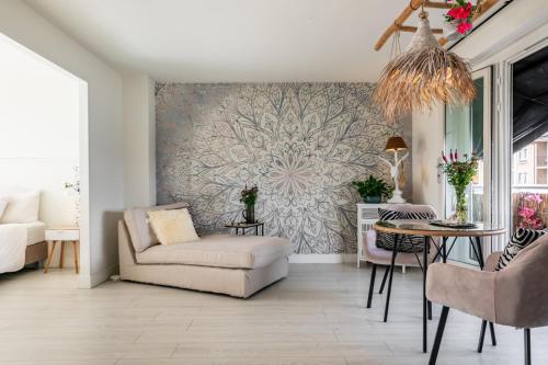 a living room with a chair and a table at Rembrandts beach view in Zandvoort