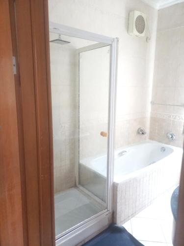 a bathroom with a shower and a bath tub at Lagos Residence - Luxury 4Bedroom Ikoyi in Lagos