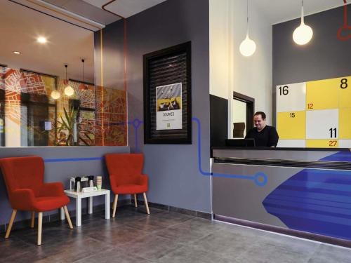 a man sitting at a counter in a restaurant at ibis Styles Marseille Gare Saint-Charles in Marseille