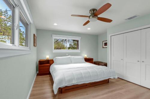 a bedroom with a bed and a ceiling fan at Napping Fox Cottage in Cranes Mill