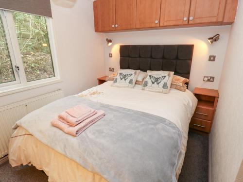 a bedroom with a bed with two towels on it at John's Folly in Sowerby Bridge