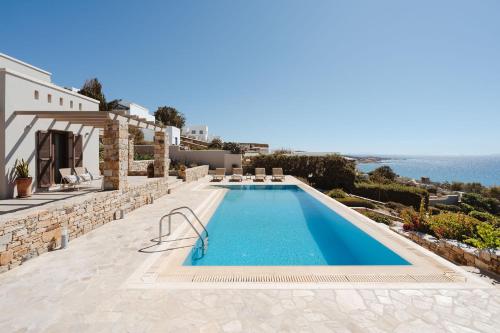 a swimming pool on the side of a villa at ZELION VILLA in Stelida