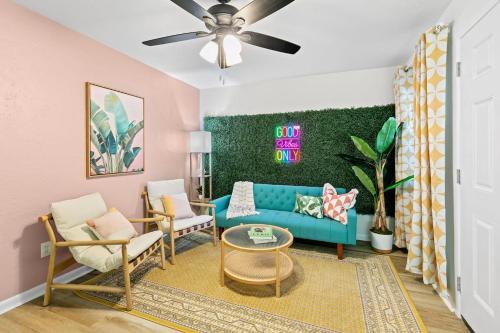 a living room with a blue couch and chairs at Near UF and Shands Cozy Retreat in Gainesville