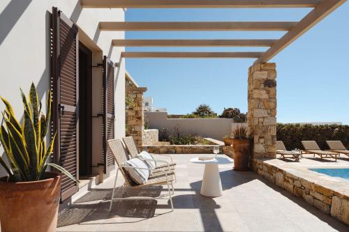 a patio with chairs and a swimming pool at ZELION VILLA in Stelida