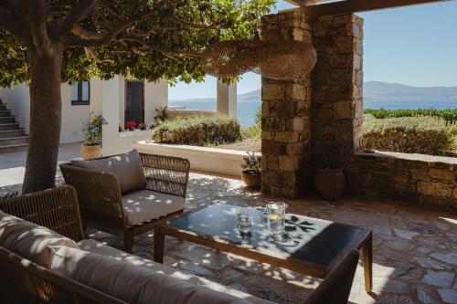 a patio with a couch and a table and chairs at ZELION VILLA in Stelida