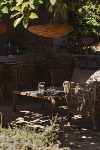 a wooden table and chairs with a glass on it at ZELION VILLA in Stelida