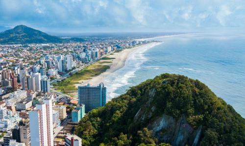 an aerial view of a city and the beach at Casa Matinhos Caioba Parana in Matinhos