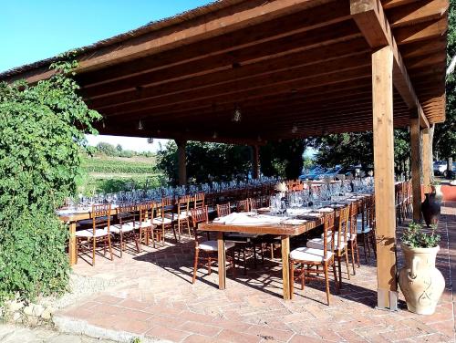 a row of tables and chairs under a pavilion at Podere Cerciano in Radicondoli