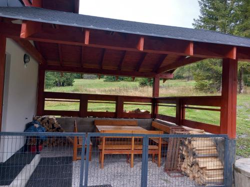 a wooden pavilion with a table and a couch at Chata pod Krivanom in Východná
