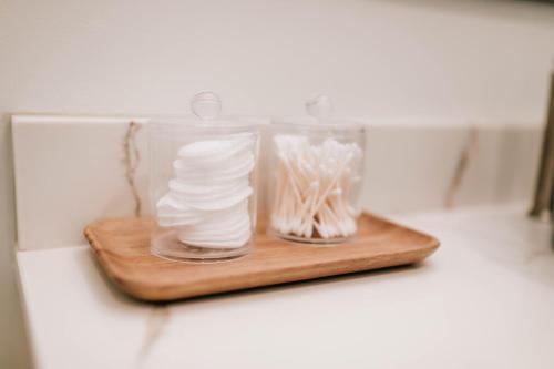 a wooden cutting board with a glass jar filled with white pasta at Luxe 2br Cabin D By Mhm Luxury Properties in Jasper