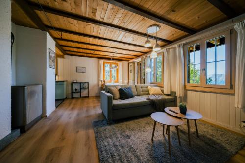 a living room with a couch and a table at Mountain Loft - Where Design Meets Nature in Axalp