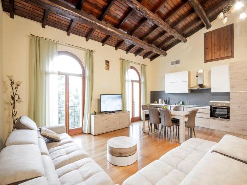 a living room with a white couch and a table at Lakeside Mansion with Pool in Artogne