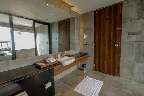 a bathroom with a sink and a mirror at Vee Resort- The Suites of Royals in Mahabaleshwar