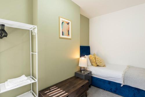 a small bedroom with a bed and a shower at Spacious 3BR Home - Comfort & Convenience in Manchester