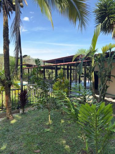 a view of a resort with palm trees at Jaragual EcoHostel in La Vega