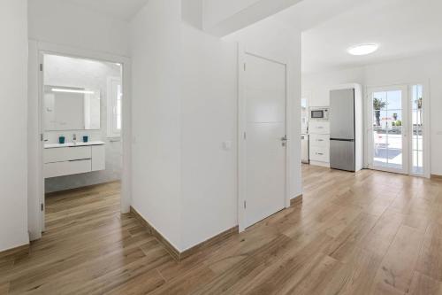 an empty room with white walls and a wooden floor at Villa Yaiza Secret 1 in Yaiza