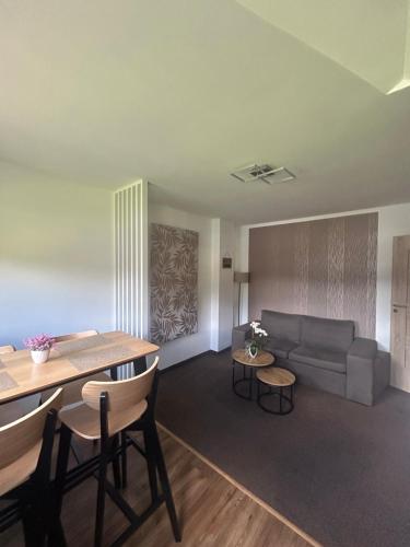 a living room with a couch and a table at Margus Apartmány in Oščadnica