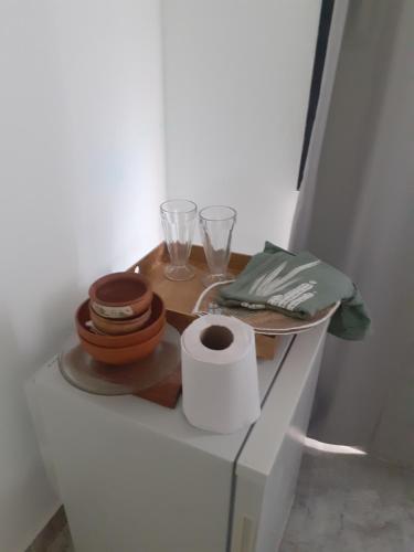 a shelf with a table with plates and glasses on it at Dionycio in Cafayate