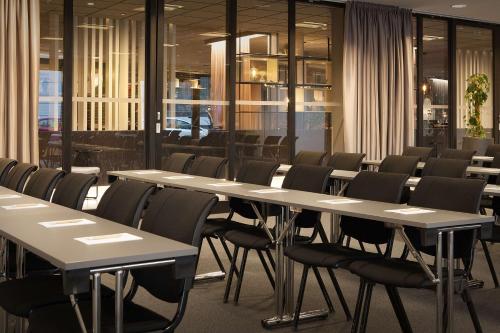 a row of tables and chairs in a room at Scandic Ambassadeur Drammen in Drammen