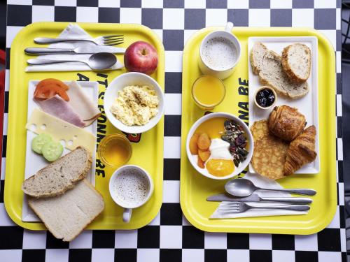 a tray of breakfast foods on a table at ibis Styles Strasbourg Nord Palais des Congrès in Schiltigheim