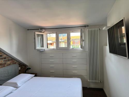 a bedroom with two beds and a window at Agaphouse Loft in Milan in Cusano Milanino