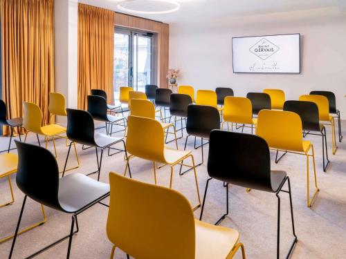 a waiting room with yellow and black chairs at Le Saint Gervais Hotel & Spa Handwritten Collection in Saint-Gervais-les-Bains