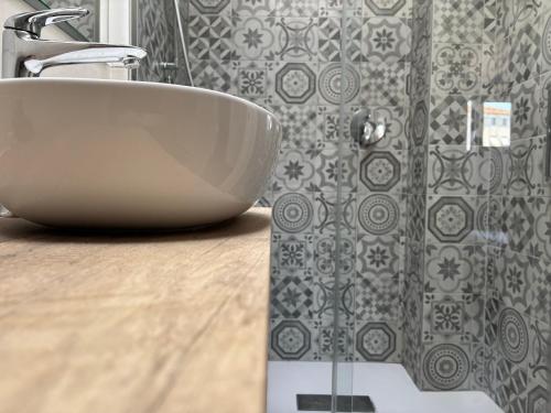 a white sink in a bathroom with a shower at Agaphouse Loft in Milan in Cusano Milanino