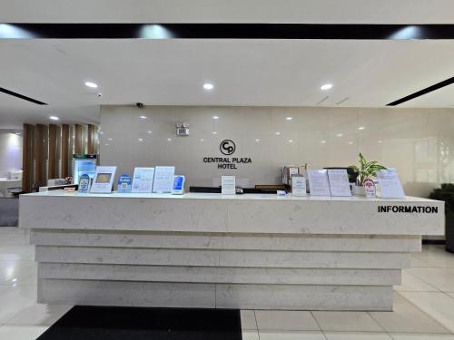 a lobby with a counter with signs on it at Central Plaza Hotel in Seryu-dong