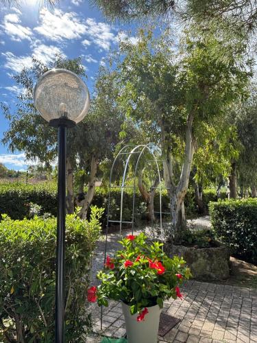 a street light with flowers in a garden at Ibiscus Beach Village in Follonica