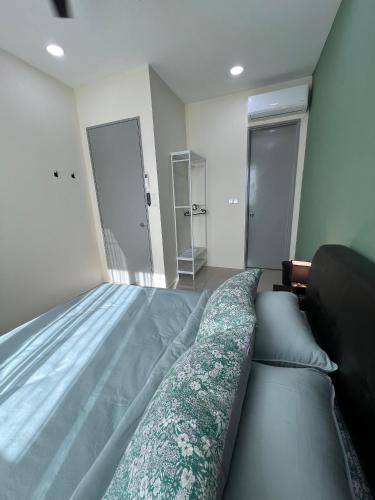 a bedroom with a large bed and two pillows at Cozy Modern Condo with Pool & City Access in Bayan Lepas