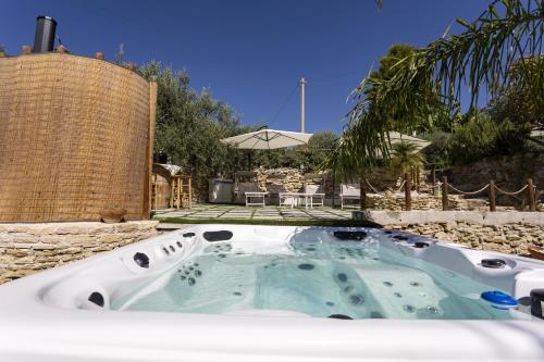 a jacuzzi tub in the backyard of a house at Villino Il Melograno in Menfi