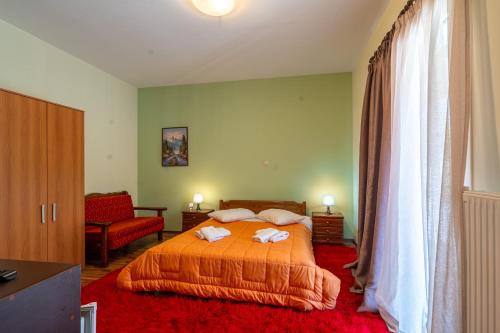a bedroom with a bed with two towels on it at Ageri in Karpenision