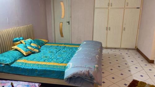 a bed with blue sheets and pillows in a room at muree cottage in Murree