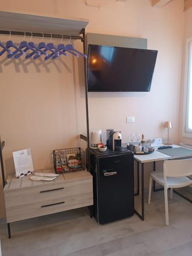 a room with a desk and a bunk bed with a refrigerator at Do Campanili by Ca-Sa Check in Chioggia
