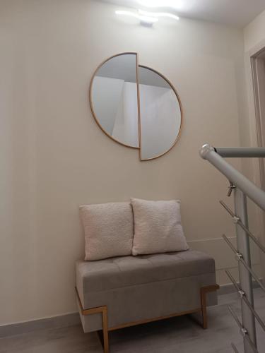 a mirror hanging on a wall next to a couch at Do Campanili by Ca-Sa Check in Chioggia