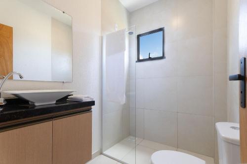 a bathroom with a shower and a sink and a toilet at Beachfront Duplex #A6 - Aquiráz By Carpediem in Aquiraz