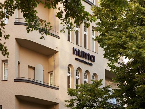a building with a hilton sign on the side of it at Numa Berlin Novela in Berlin