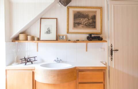 a bathroom with a sink and a staircase at Charmant manoir Sud de Paris in Saint-Sauveur-sur-École