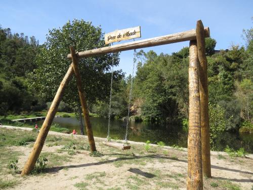 a swing yard with a sign and a river at Manecas House Creative in Reriz