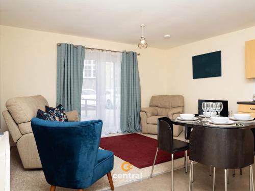 a living room with a dining room table and chairs at Bellfield by CENTRAL SERVICED APARTMENTS - Walk away from Dundee University - 2 Bedrooms - 2 Bathrooms - 2 King Beds - Smart TVs - Fully Equipped - Parking - Close to City Centre in Dundee