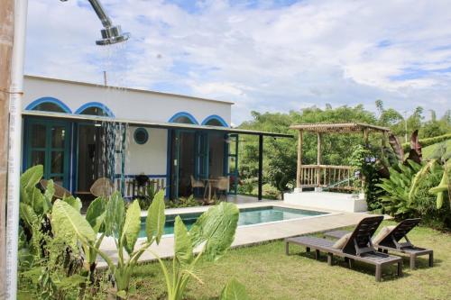 a villa with a swimming pool in a garden at Piscina privada in Alcalá