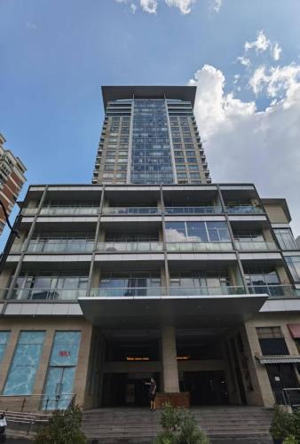 a tall building with a blue sky in the background at River House Near The Peoples Square And The Bund in Shanghai
